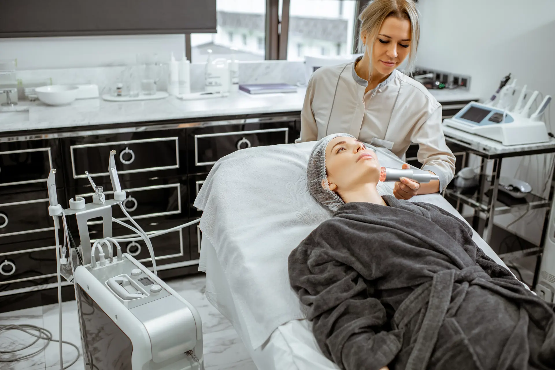 A cosmetologist performing a facial treatment