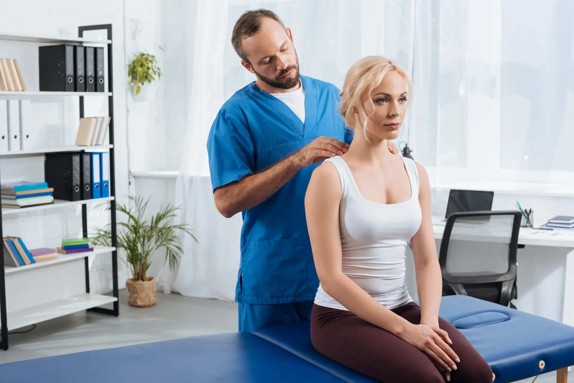 A physiotherapist massaging a patient's shoulders