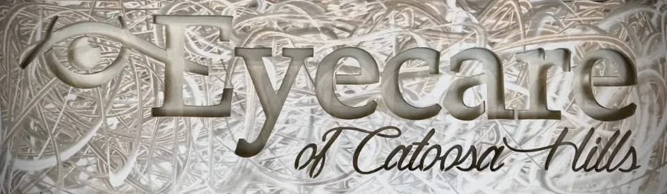 The carved Eyecare of Catoosa Hills sign