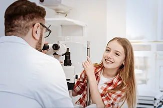 Optometrist discussing eye exam results with smiling patient
