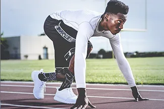 Athlete stretching on field while wearing contact lenses