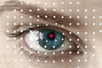 Close-up of eye with red cross and digital overlay for exam
